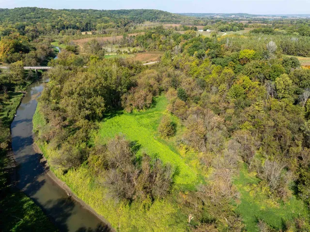 an aerial view of residential houses with outdoor space and trees