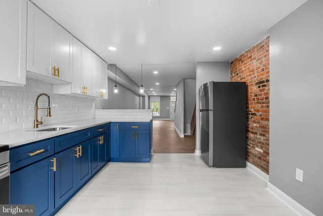 a kitchen with stainless steel appliances a refrigerator and a sink