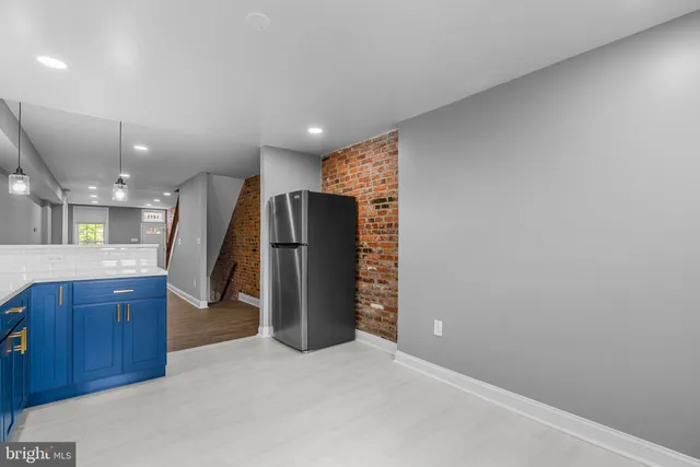 a view of a kitchen with a refrigerator and a sink