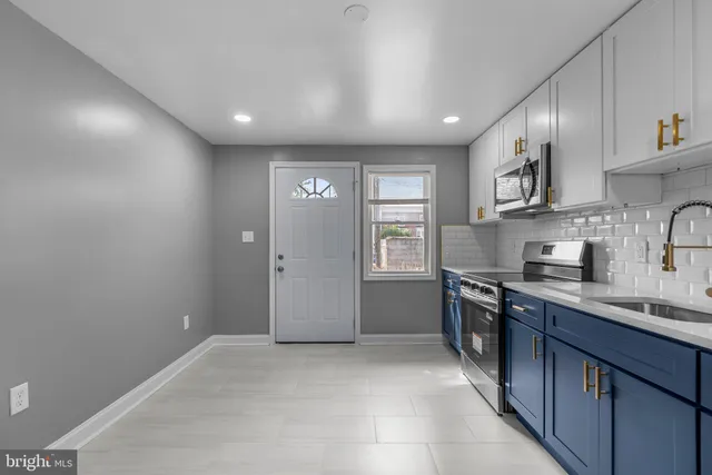 a kitchen with stainless steel appliances granite countertop a sink and stove