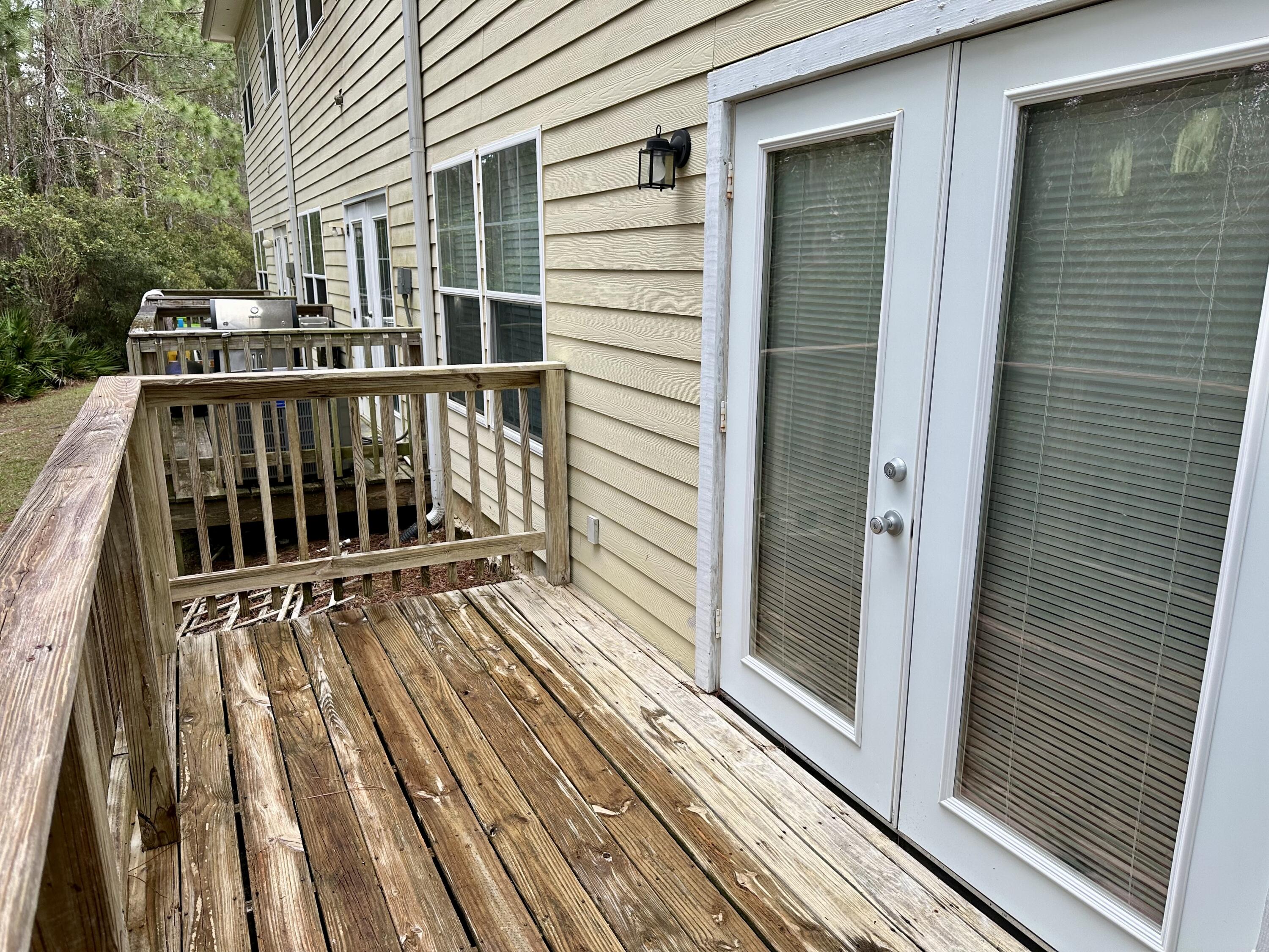 732 East Mack Bayou Drive, Unit 2 Santa Rosa Beach, FL 32459 - Photo 34 of 43 a view of deck with wooden floor and fence and a lots of trees