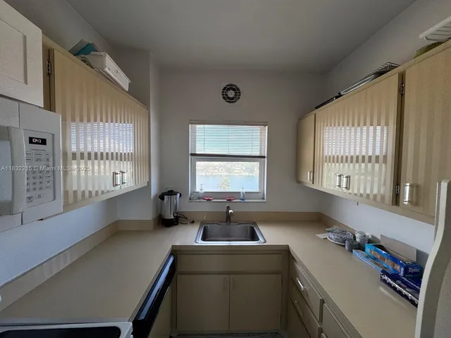 a bathroom with a bathtub a sink a mirror and a window