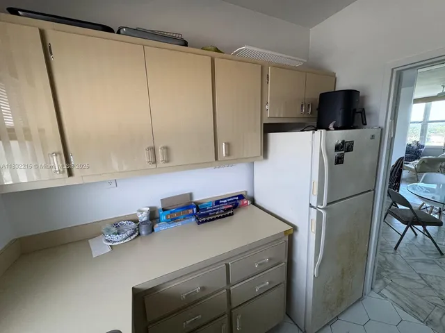 a kitchen with stainless steel appliances a refrigerator and a sink