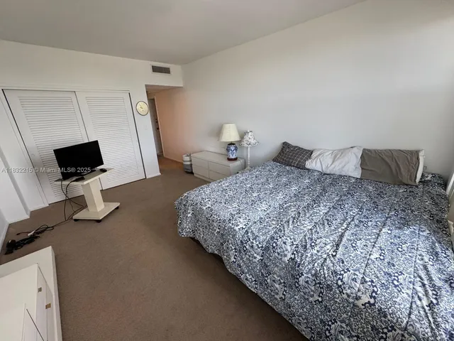 a bedroom with a bed and chair