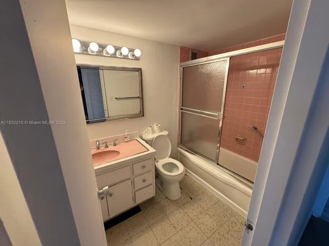 a bathroom with a toilet sink and shower
