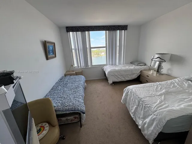 a bedroom with two beds and a window