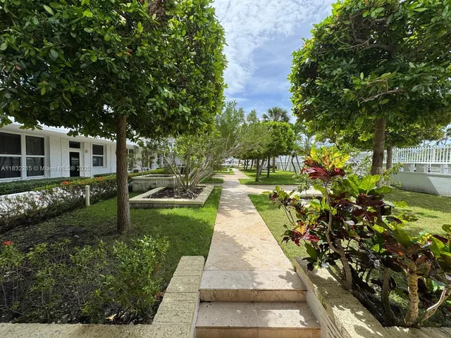 a pathway of a house with a yard