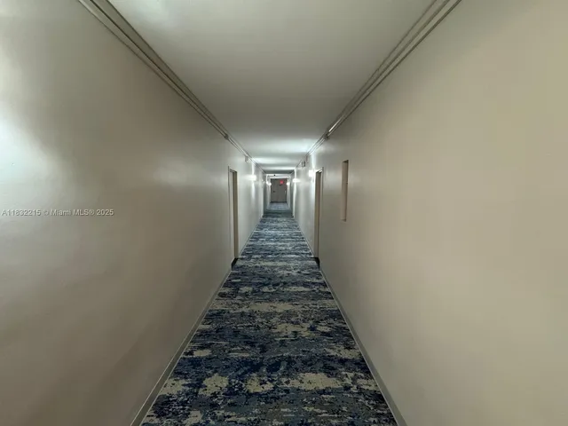 a view of a hallway with a flower pot