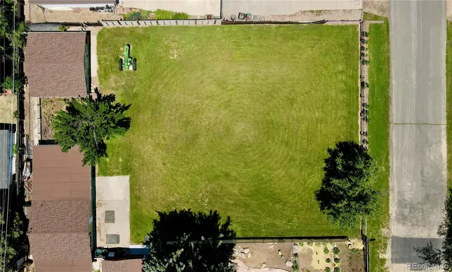an aerial view of a house with a yard