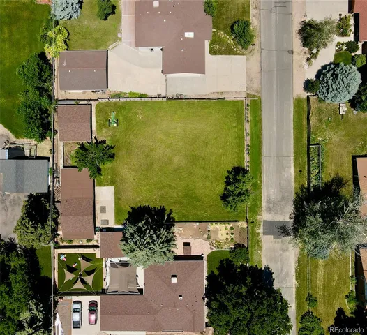 an aerial view of a house with a yard swimming pool and outdoor seating