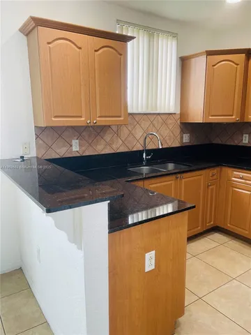 a kitchen with granite countertop cabinets and sink