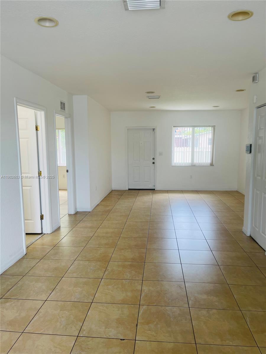 1370 West 30th Street, Unit 1370 Hialeah, FL 33012 - Photo 12 of 23 a view of an empty room and window