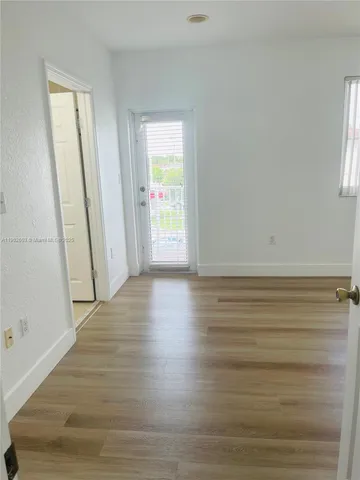 a view of wooden floor and windows in a room