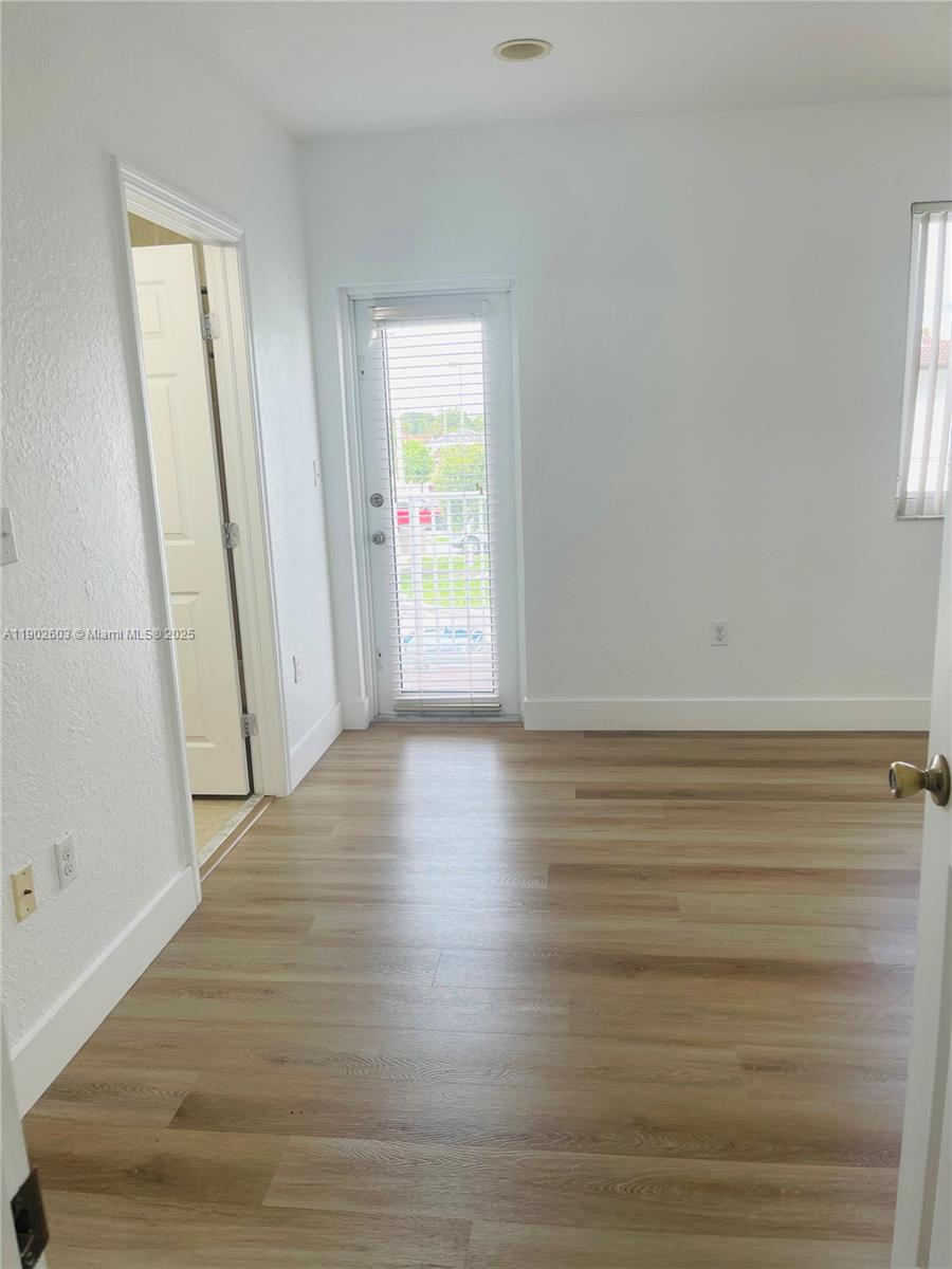 1370 West 30th Street, Unit 1370 Hialeah, FL 33012 - Photo 21 of 23 a view of wooden floor and windows in a room