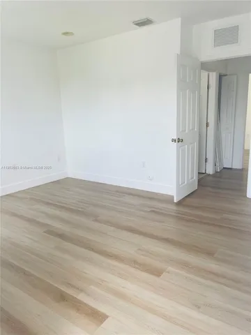 an empty room with wooden floor