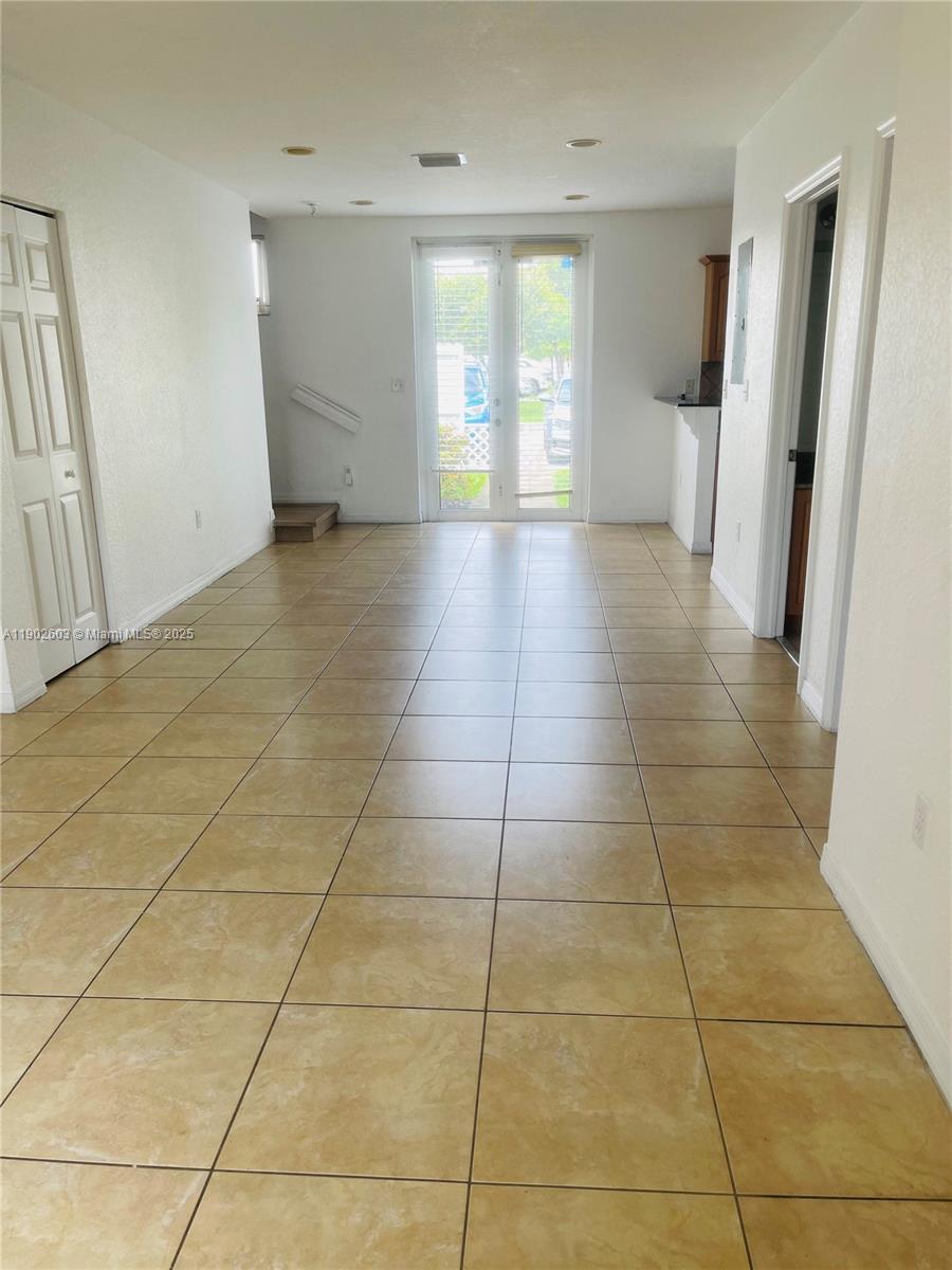 1370 West 30th Street, Unit 1370 Hialeah, FL 33012 - Photo 6 of 23 a view of an empty room with a window