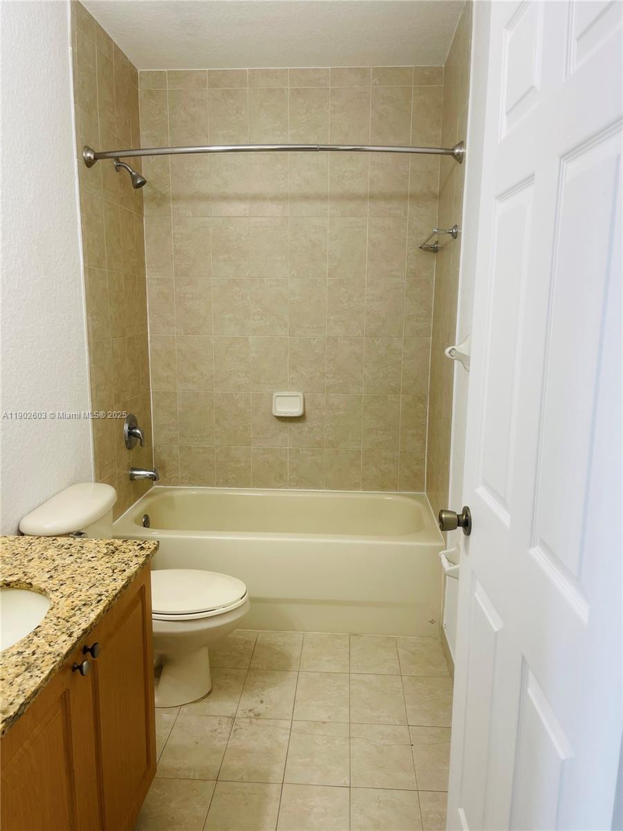 1370 West 30th Street, Unit 1370 Hialeah, FL 33012 - Photo 9 of 23 a bathroom with a granite countertop bathtub sink vanity mirror and toilet