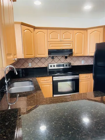 a kitchen with a stove and a cabinet