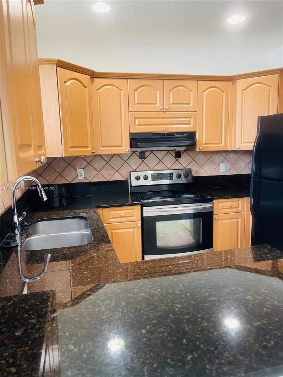 1370 West 30th Street, Unit 1370 Hialeah, FL 33012 - Photo 10 of 23 a kitchen with a stove and a cabinet