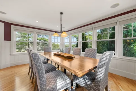 a view of a dining room with furniture window and wooden floor