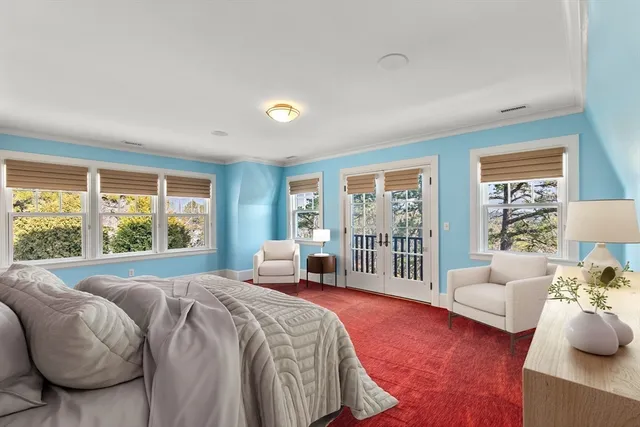 a spacious bedroom with a bed and glass window