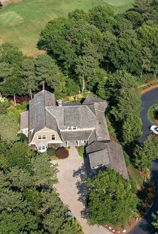 an aerial view of a house with swimming pool and garden