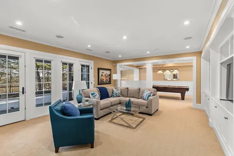 a living room with furniture and large windows
