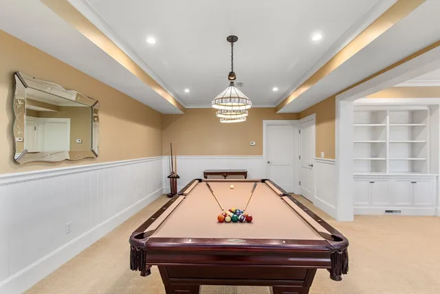 a room with pool table and windows