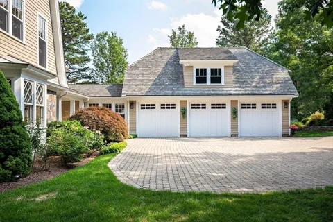 a front view of a house with a garden and yard