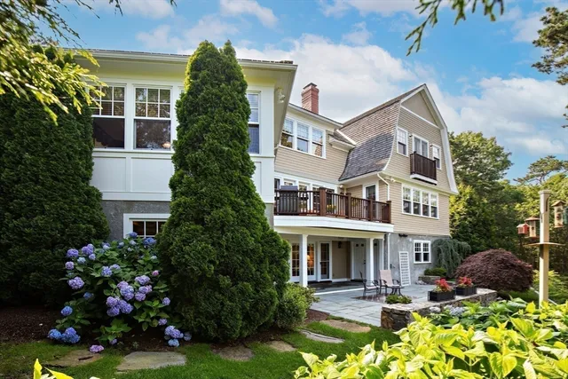 a front view of a multi story residential apartment building with yard and retail shops