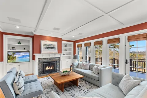 a living room with furniture a rug and a fireplace