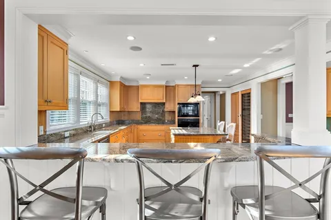 a view of a dining room with furniture and a large window