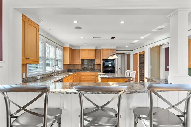 a view of a dining room with furniture and a large window