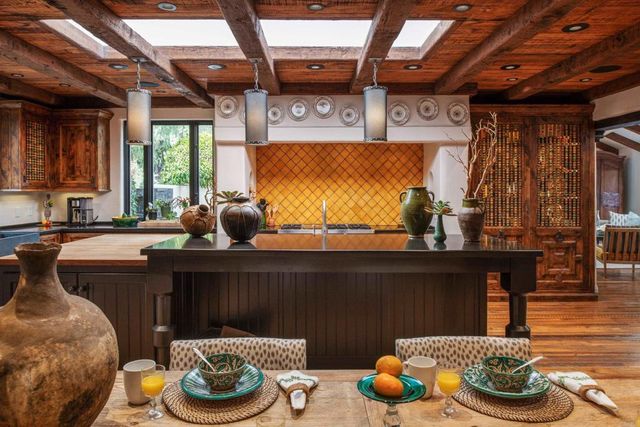 a kitchen with a table and a chair