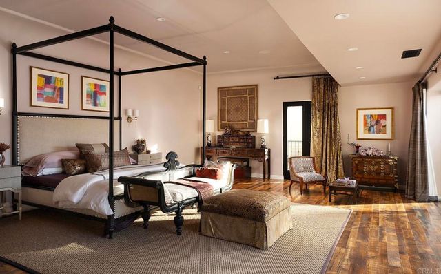 a bedroom with furniture and a chandelier