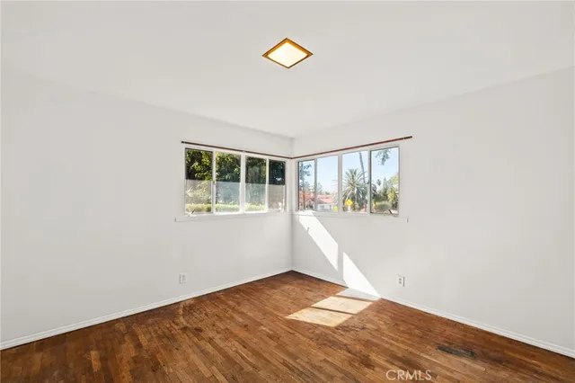 a view of a house with a yard and a tree