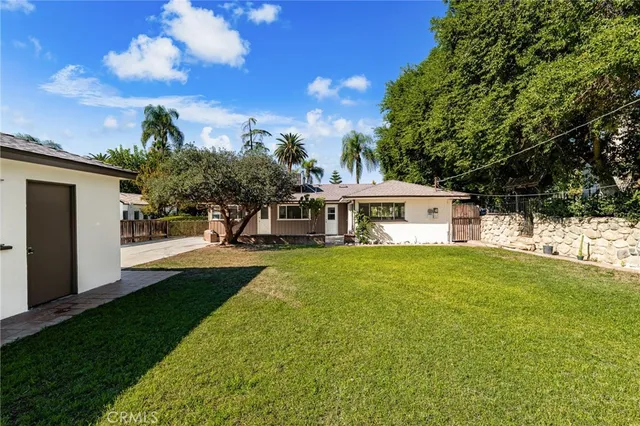 an aerial view of a residential houses with outdoor space