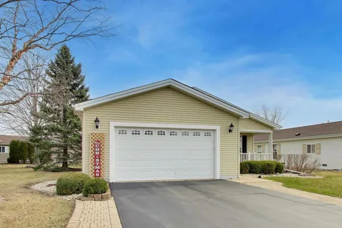 a view of a house with a yard and garage