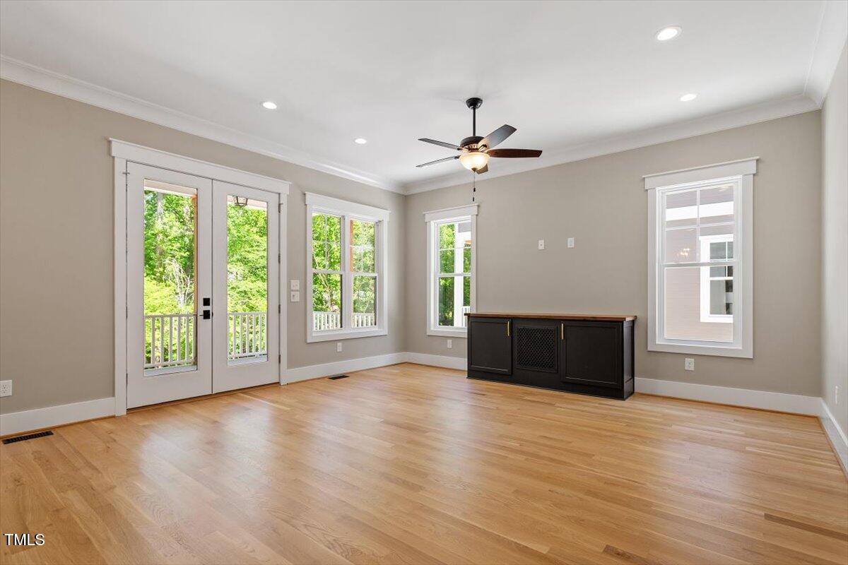 3934 Old Chapel Hill Road Durham, NC 27707 - Photo 4 of 47 a view of empty room with wooden floor and fan