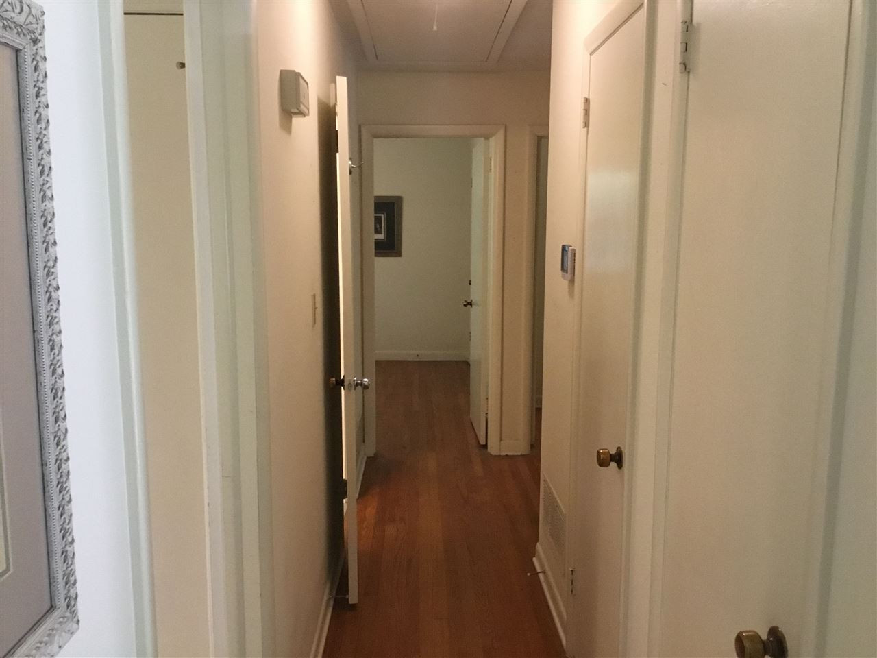 519 West Cornwall Road Cary, NC 27511 - Photo 15 of 29 Hallway with hardwood floors and closets for storage Hallway