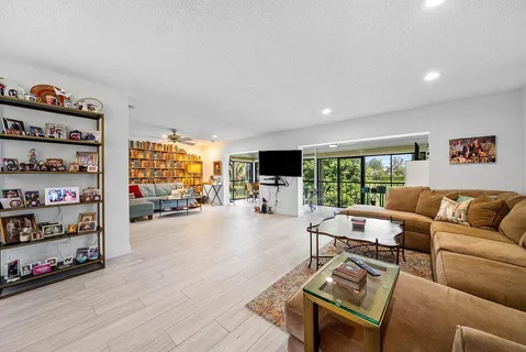 a living room with furniture window and a flat screen tv