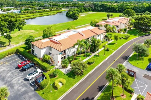 an aerial view of residential houses with outdoor space and street view