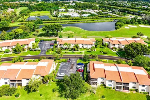 an aerial view of residential houses with outdoor space and swimming pool