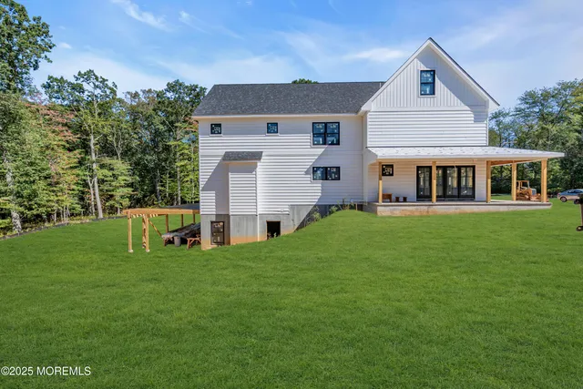 a front view of a house with a yard and trees
