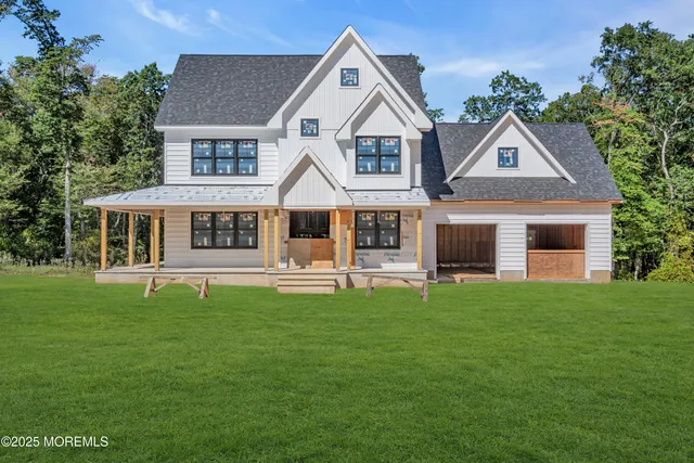a front view of a house with a garden and porch