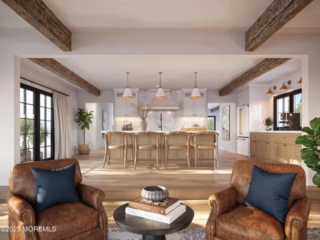 a living room with furniture kitchen view and a chandelier