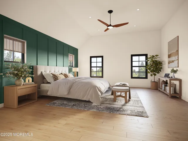 a spacious bedroom with a bed couch and windows