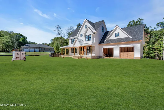 a view of a house with a big yard and potted plants