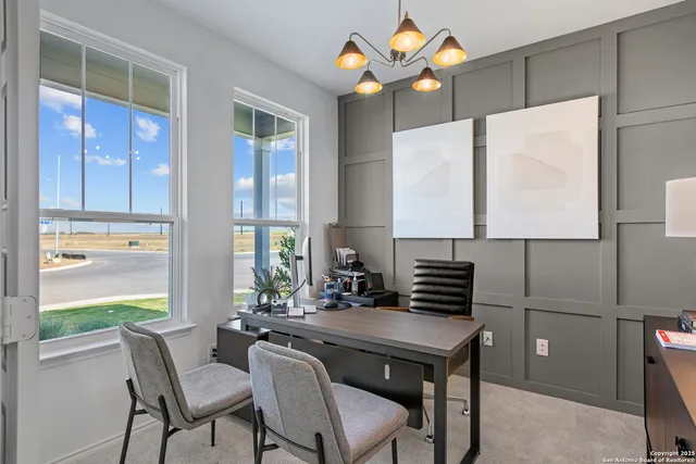 a kitchen with a table chairs and a refrigerator