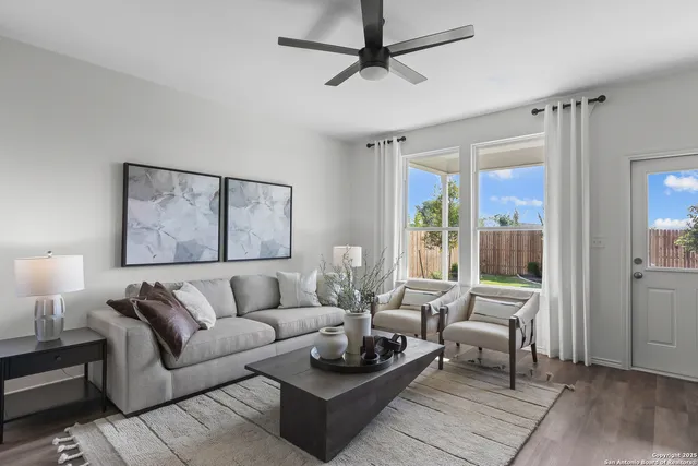 a living room with furniture and a large window